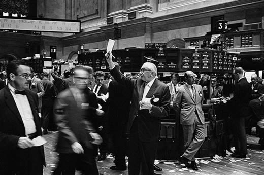 Historical photo of stock traders and stock brokers in the trading floor of the New York Stock Exchange.